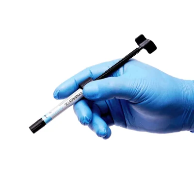 Coltene Synergy D6 Syringe in hand in blue gloves